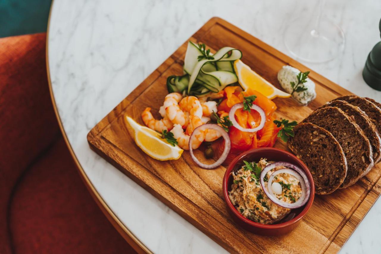 a plate of food with shrimp and bread on a table at Parade Hotel Bath in Bath